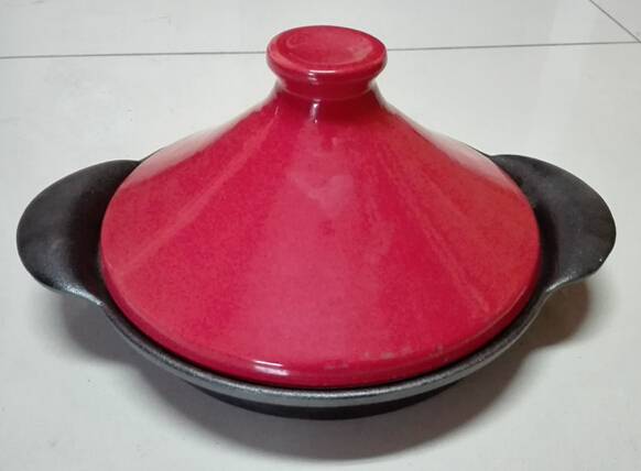 Red color cast iron tagine pot with ceramic lid