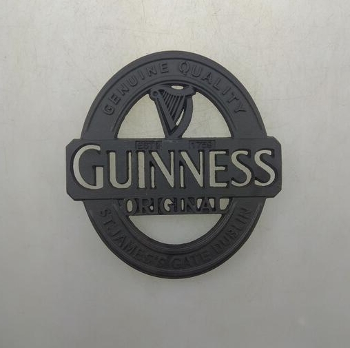 Black cast iron table mat with Guinness logo