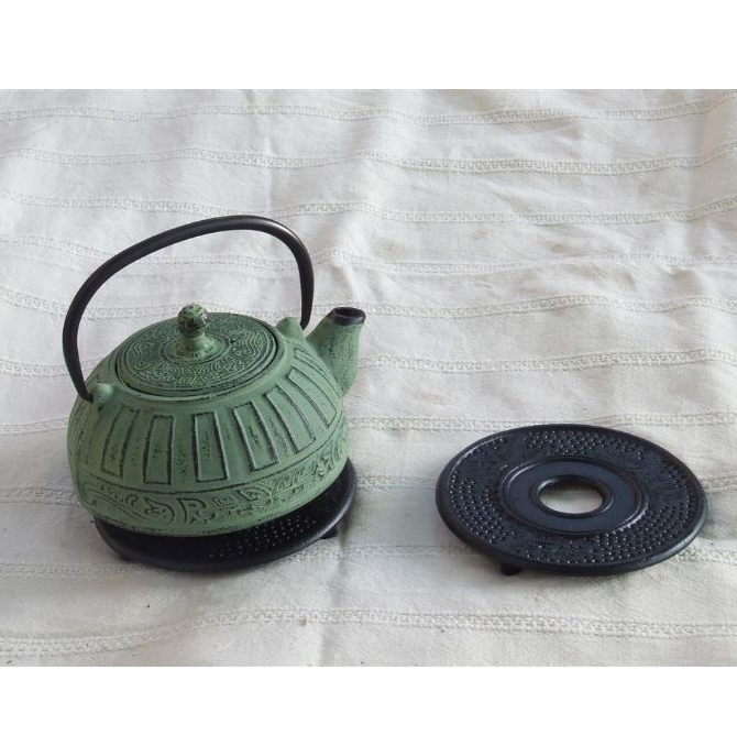 cast iron teapot with infuser green color black trivet