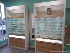 Custom Wooden veneer and S.Steel Eyeglass shop interior displays design