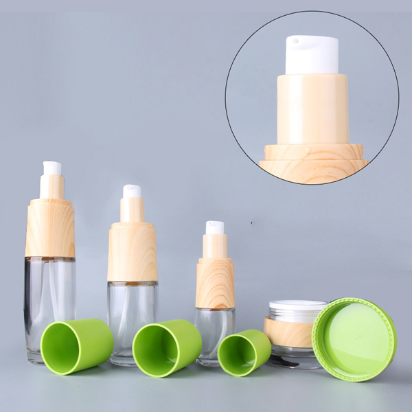 Wholesale Green high-grade skin care pressure pump lotion glass bottle clear empty face cream jar Featured Image