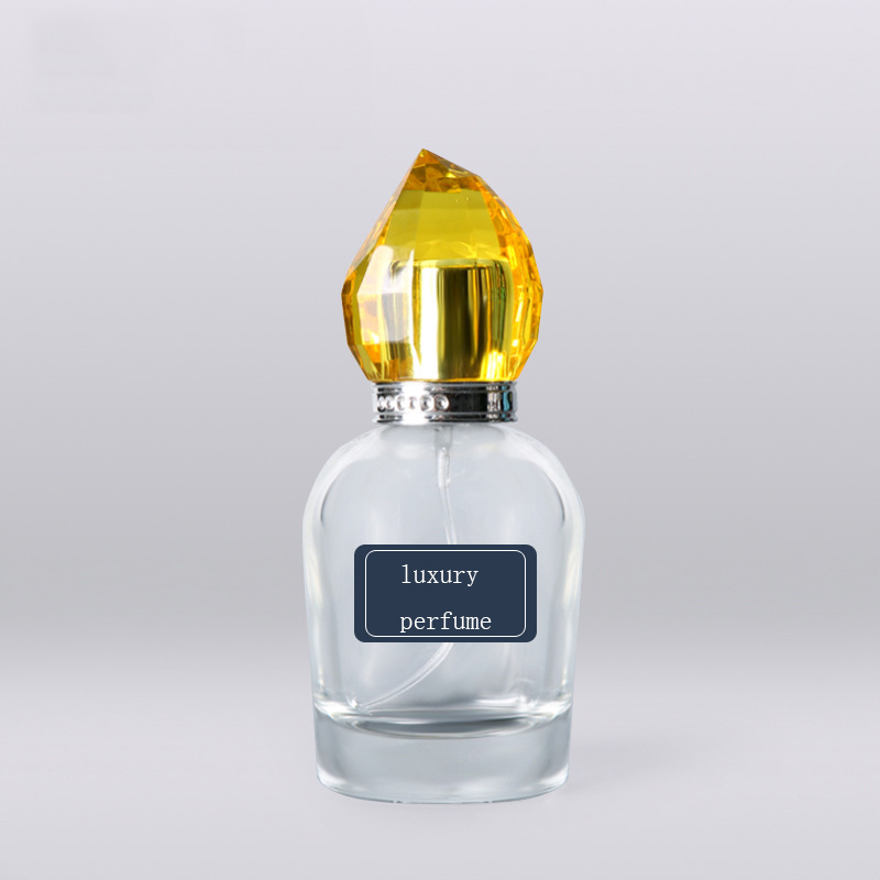 100ml luxury transparent round glass perfume bottle with golden acrylic plastic cap Featured Image