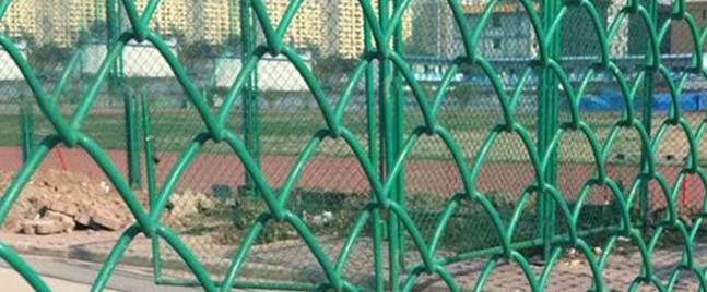 What role does the chain link fence play on the basketball court?